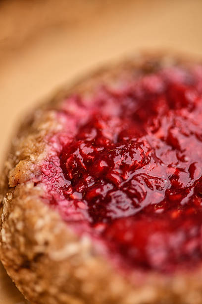 Macro Close-Up of Raspberry Jam Tart With Glossy Red Berry Topping
