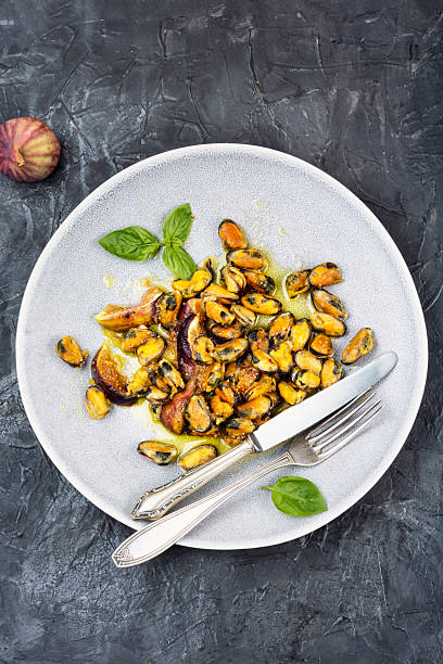 Delicious fried peeled mussels with figs