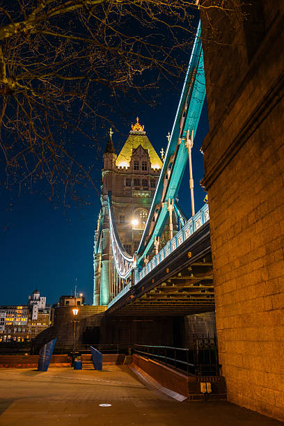 Tower bridge glowing with lights at night, showcasing iconic architecture