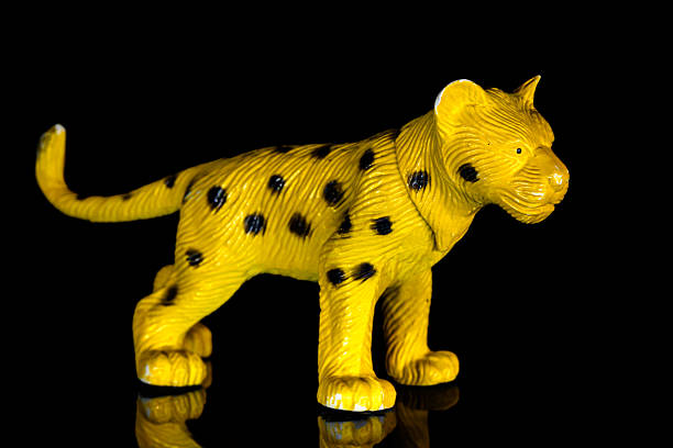 a small, plastic leopard or cheetah toy figurine designed for children.