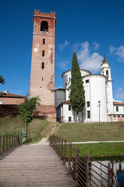 Castelfranco Veneto, Italy - 2023, October 21 : A medieval tower and the back of the cathedral of the town of Castelfranco Veneto in the Treviso province of northern Italy