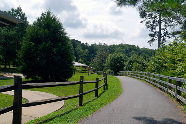 A fence-lined path invites pedestrians, bikers, swimmers, and golf carts down to the water's edge at Lake Norman State Park in Iredell County, North Carolina. 2025
