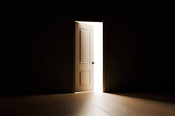 Open Door with Bright Light Streaming Into Dark Room