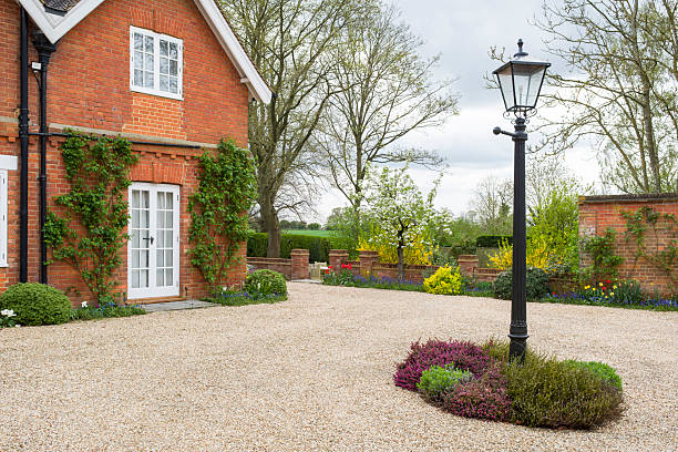 Large English country house, home with lamppost and courtyard garden in spring, UK