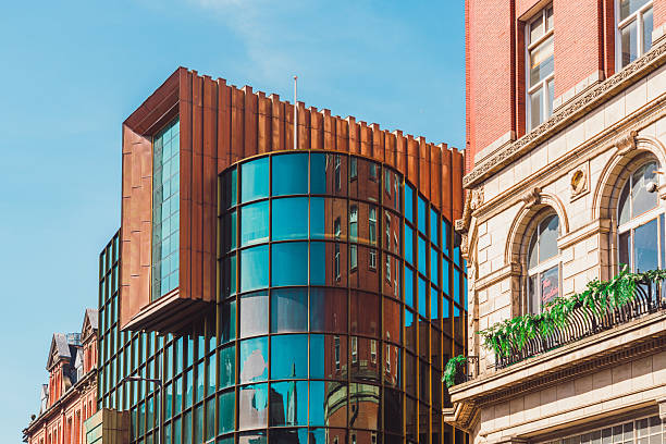 Modern building with glass facade reflecting traditional brick architecture in liverpool