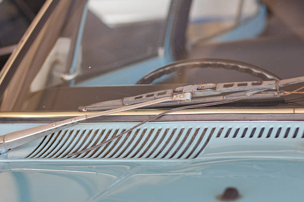 Close up of the windshield wipers and  cowl vent on a classic vintage car.