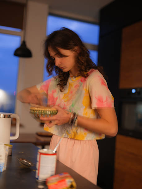 Woman preparing food on a modern kitchen at night