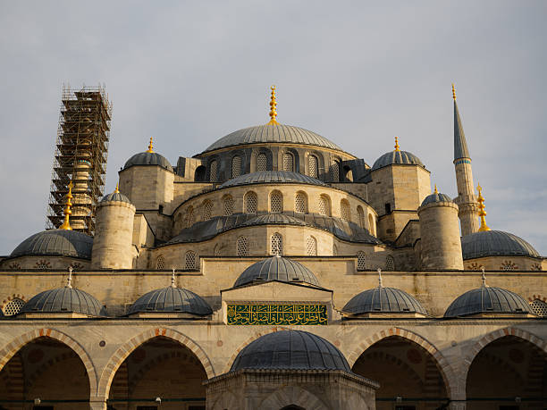 The monumental Sultan Ahmed Mosque, or Blue Mosque, features its iconic cascading domes and slender minarets under a soft, overcast sky