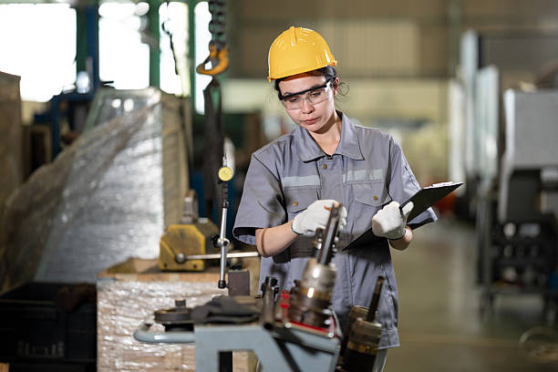 Woman engineer working with checking machine at auto parts factory