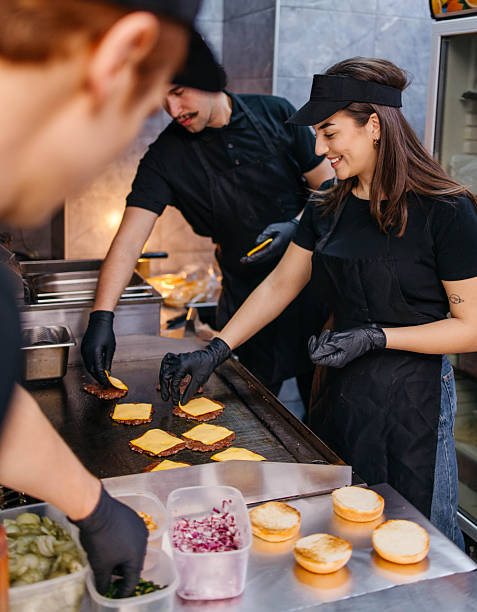 Friends are making burgers in their fast food restaurant.
