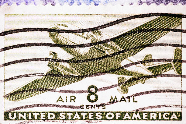 Close-up of United States Air Mail stamp with aircraft design. Concept of aviation history, postal services, air transport and communication.