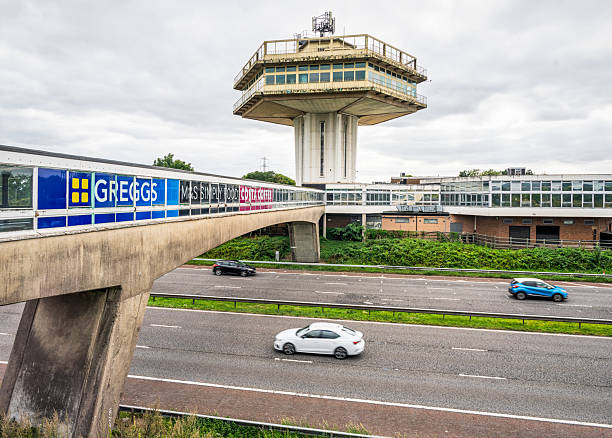 Forton Services, UK - Cars on the M6 passing the landmark 1960s tower and footbridge of the Lancaster Forton motorway services.