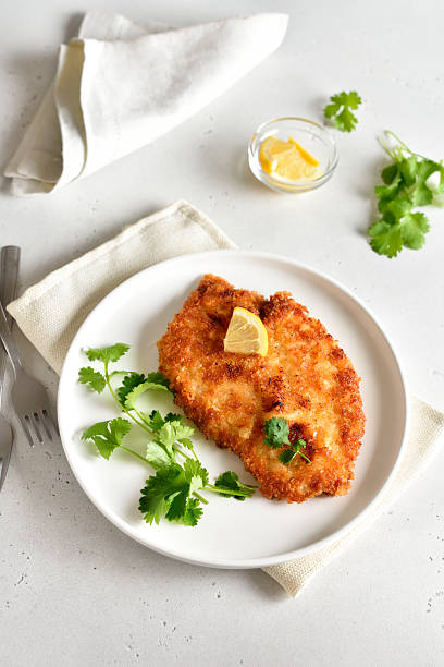 Chicken schnitzel on white plate