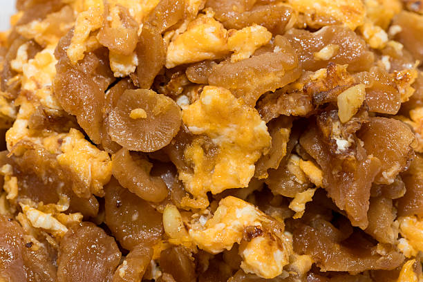 Close-up of homemade stir-fried preserved radish with eggs, appetizing Thai-style dish with rich texture and detailed appearance