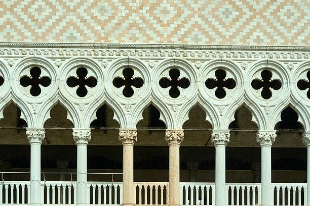 Doge's palace in venice, italy, showing gothic architectural details, including quatrefoil windows and patterned a brick facade