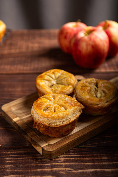 Golden Crust Individual Apple Pie on Rustic Wood Serving Board