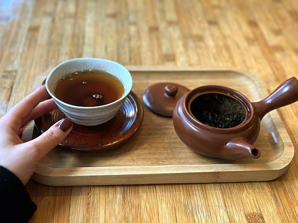 A hand gently touching a teacup