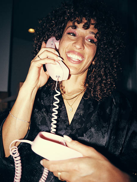A woman relaxing, wearing a robe, in a home Filmed in a retro 70s/80s camera film style.
