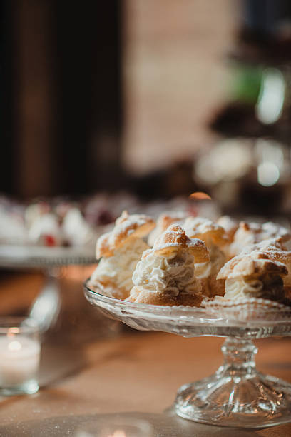 Dessert stand with cream puffs filled with whipped cream