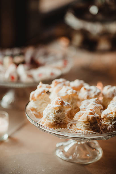 Close up of tray of vanilla cream puffs and eclairs