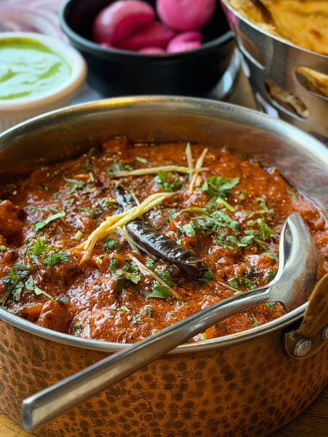 Image of rich kadhai chicken tikka masala, creamy butter chicken curry, authentic Indian meal food, bold spices, tender meat