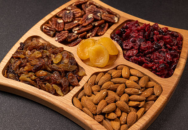 Healthy nuts and dried fruit snack on wooden tray