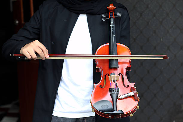 A violin is a four-stringed, bowed musical instrument, acting as the smallest and highest-pitched member of the string family.