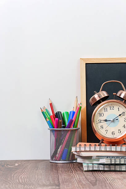 Back to school supplies with clock and chalkboard