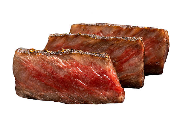 Grilled sliced Wagyu beef, perfectly cooked with rich marbling and juicy texture, isolated on white background with clipping path, high-resolution image