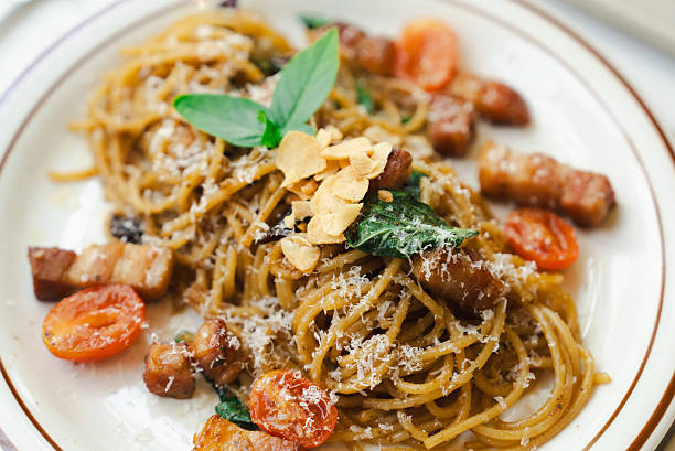 Italian style pasta with bacon and basil on table