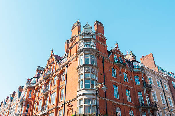 Ornate brick victorian building facade in london featuring bay windows and architectural details