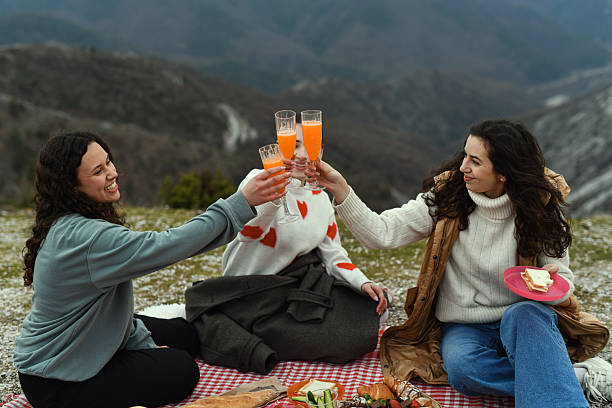 Cheerful Group of Women Toasting Drinks and Celebrating Friendship