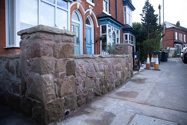 Builder restoring a stone wall on a domestic property