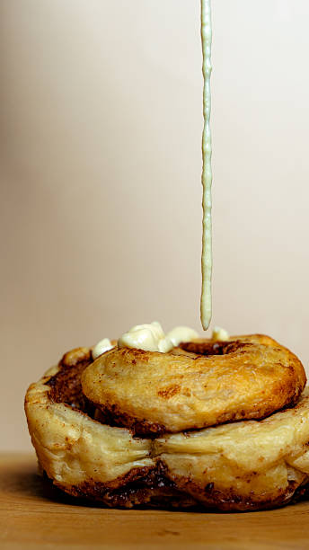 Drizzling icing on a warm cinnamon roll