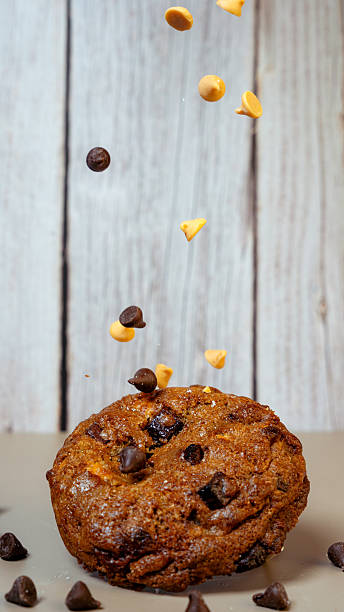 Chocolate chip cookie with peanut butter chips falling