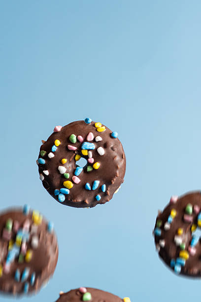 Colorful Sprinkled Chocolate Donuts in Motion