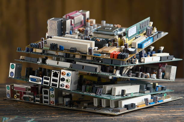 Pile of old computer motherboards stacked together. Concept of electronic waste, recycling and outdated technology.