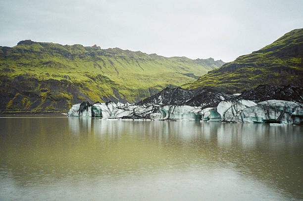 Dramatic Solheimajokull glacier and summer mountains of Summer Iceland, Scandinavia. Shot by point and shoot 35mm camera
