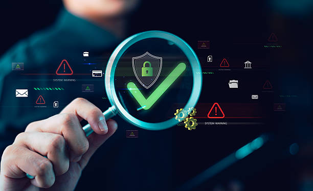 Cybersecurity analyst verifies data protection system using magnifying glass, ensuring network security, risk management, threat detection, privacy compliance, and secure digital infrastructure. Cybersecurity analyst verifies data protection system using magnifying glass, ensuring network security, risk management, threat detection, privacy compliance, and secure digital infrastructure. Technologies stock pictures, royalty-free photos & images