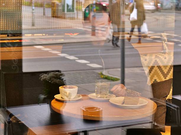 A creative double-exposure effect captured through a cafe window. A creative double-exposure effect captured through a cafe window.