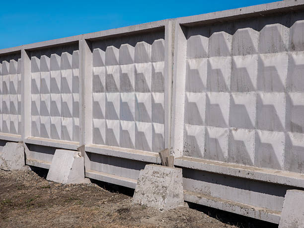 Concrete fence with square pattern against blue sky minimalist architectural design strict geometric forms. stock photo