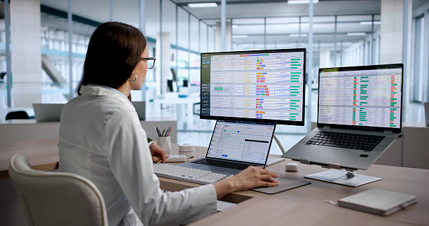 Young Woman Medical Coding Specialist Reviews Billing Data stock photo