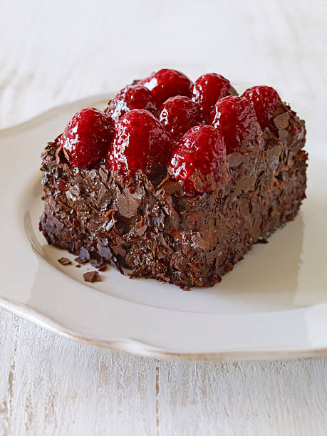 Decadent chocolate raspberry cake slice served on a ceramic plate Decadent chocolate raspberry cake slice served on a ceramic plate