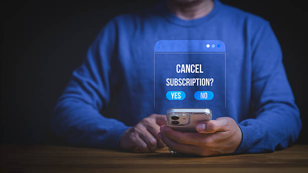 Man using smartphone to cancel subscription on digital app interface. Unsubscribe from online service membership or payment plan. Mobile technology concept for business. Man using smartphone to cancel subscription on digital app interface. Unsubscribe from online service membership or payment plan. Mobile technology concept for business. subscription stock pictures, royalty-free photos & images