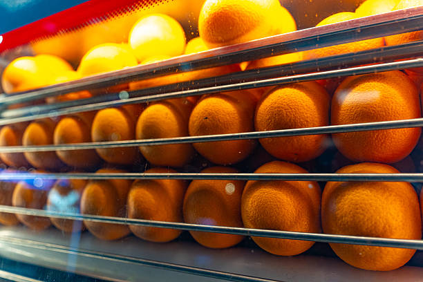 fresh oranges arranged in a refrigerated display case fresh oranges arranged in a refrigerated display case