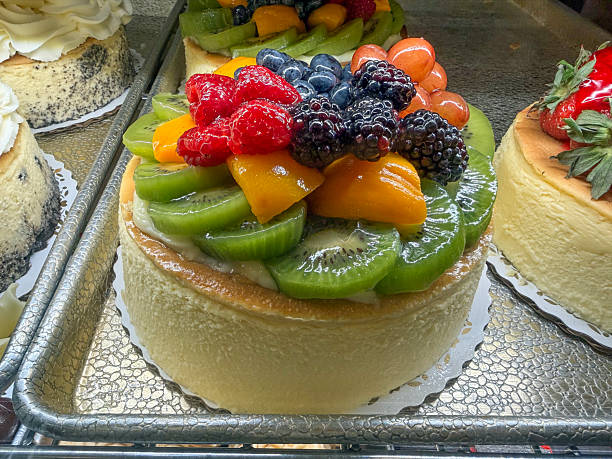 Fruit Topped Cheesecake With Glazed Fruit on Bakery Display Tray Fruit Topped Cheesecake With Glazed Fruit on Bakery Display Tray