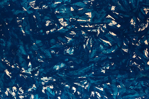Deep blue tones swirl in abstract, textured patterns stock photo