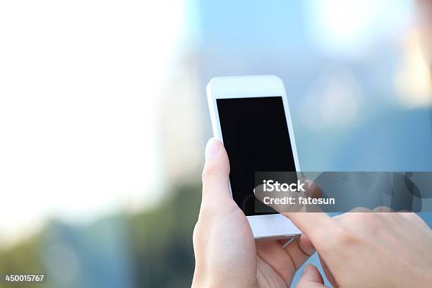 Touching Smart Phone Stock Photo - Download Image Now - Human Hand, Smart Phone, Outdoors