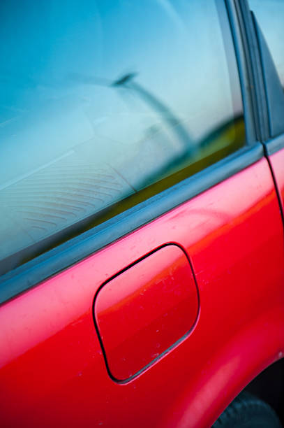 istock red car stands next to the field 450016889