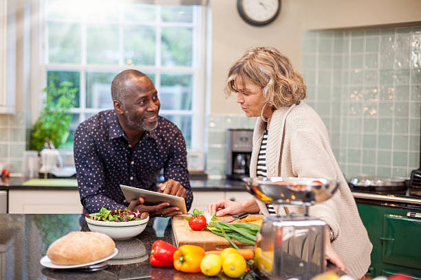 istock Multi-ethnic mature couple preparing food 450016927